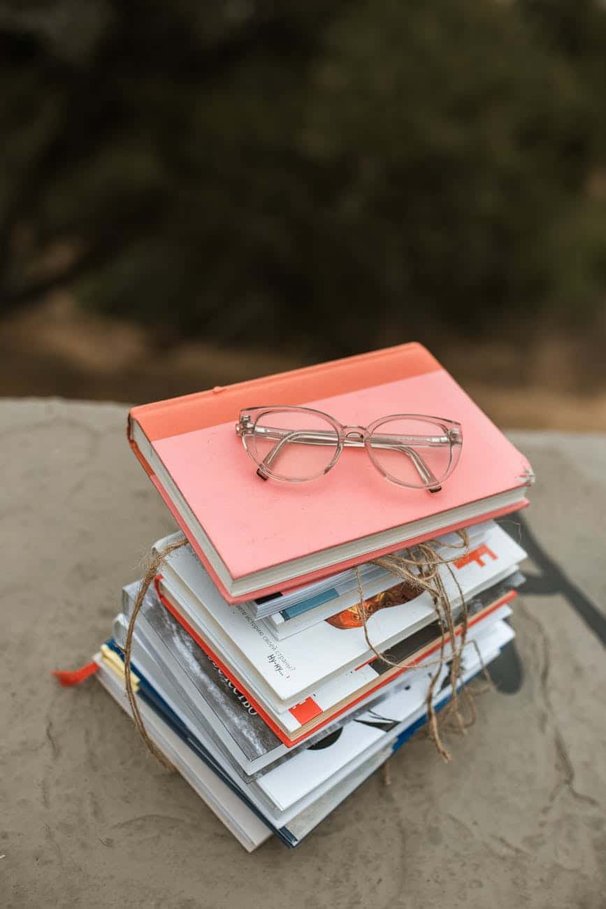 eyeglasses on stack of books