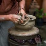 woman making clay pot