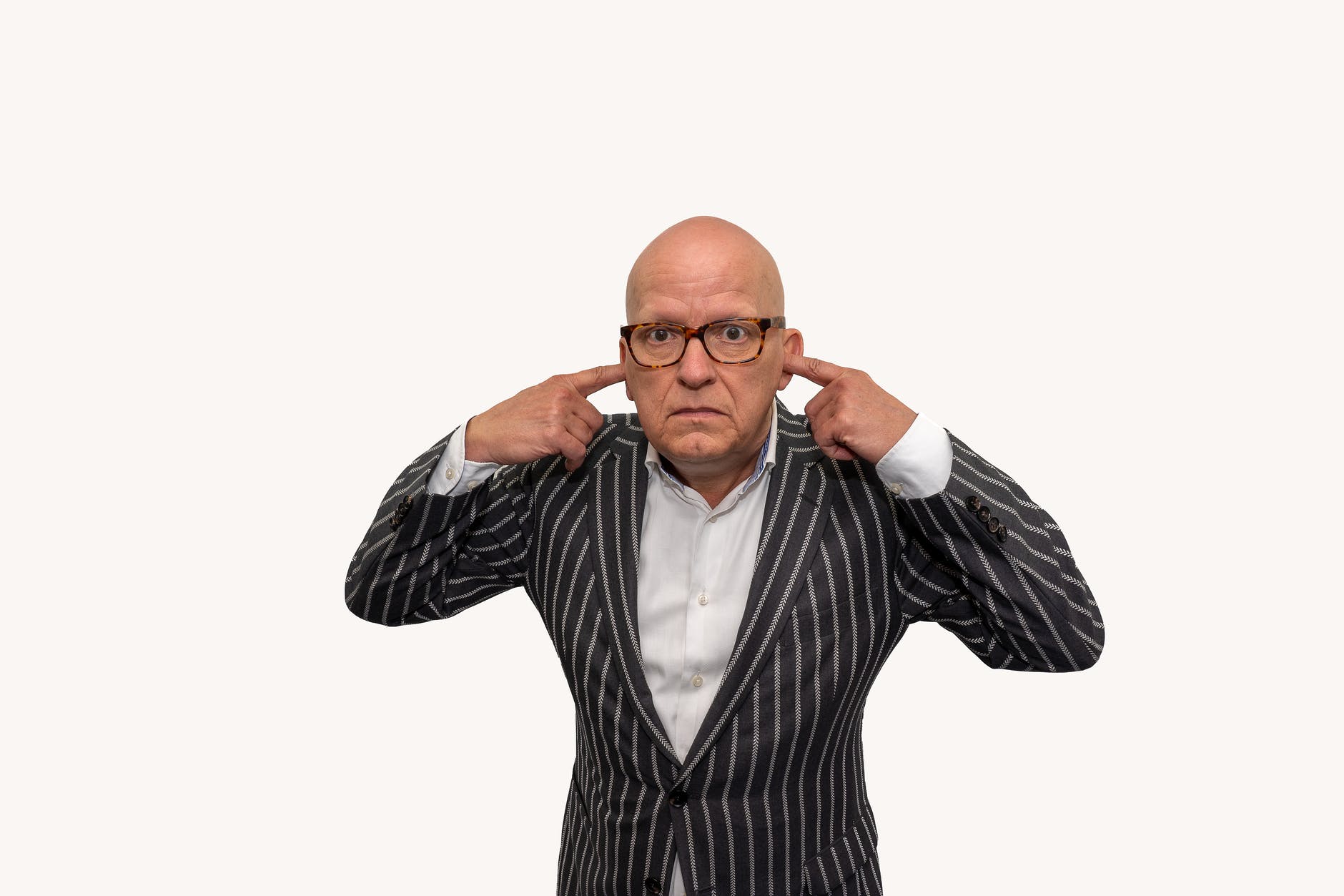 bald man covering ears with his fingers