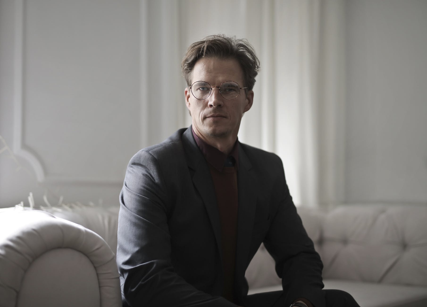well dressed businessman sitting on sofa